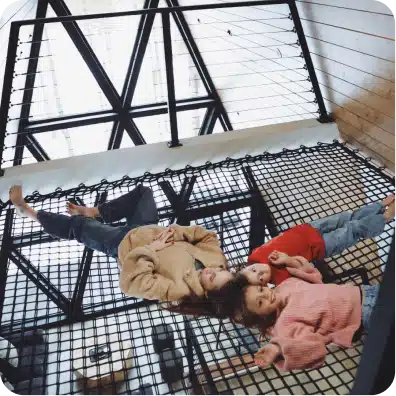 Guests resting in the cabin’s suspended net above the living room